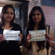 Two girls hold up sanitary napkins in Hauz Khas Village, Delhi.
